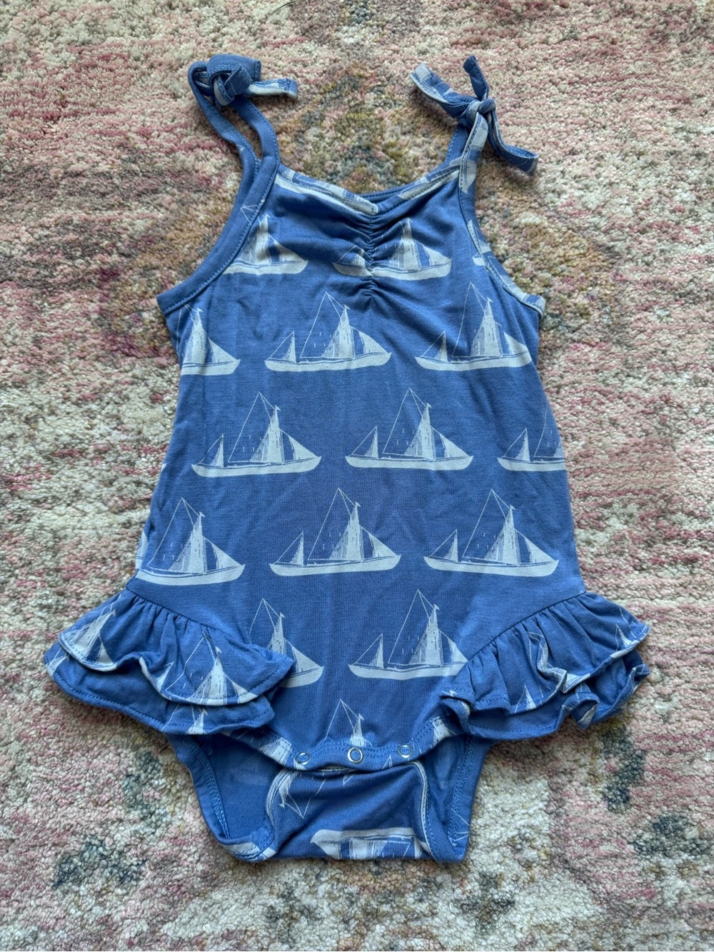 Kate Quinn tie strap ruffled sailboat onesie